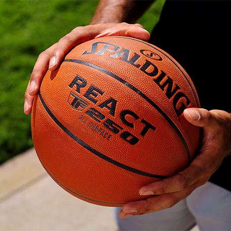 Male Model holding React TF 250 basketball.